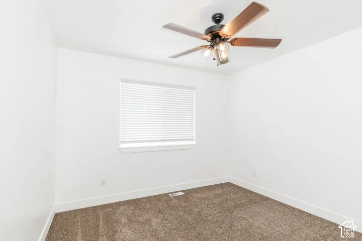 Neutral white walls with a window featuring blinds