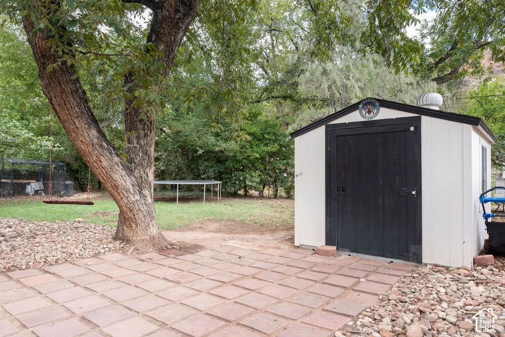 Patio area with square pavers and surrounding gravel