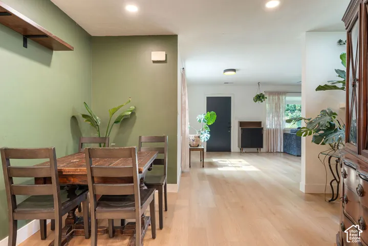 Recessed ceiling lighting, wood-finish flooring, two-tone wall paint, built-in shelving, and a solid entry door