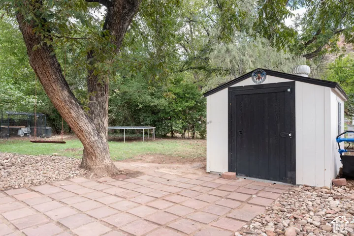 Patio area with square pavers and surrounding gravel