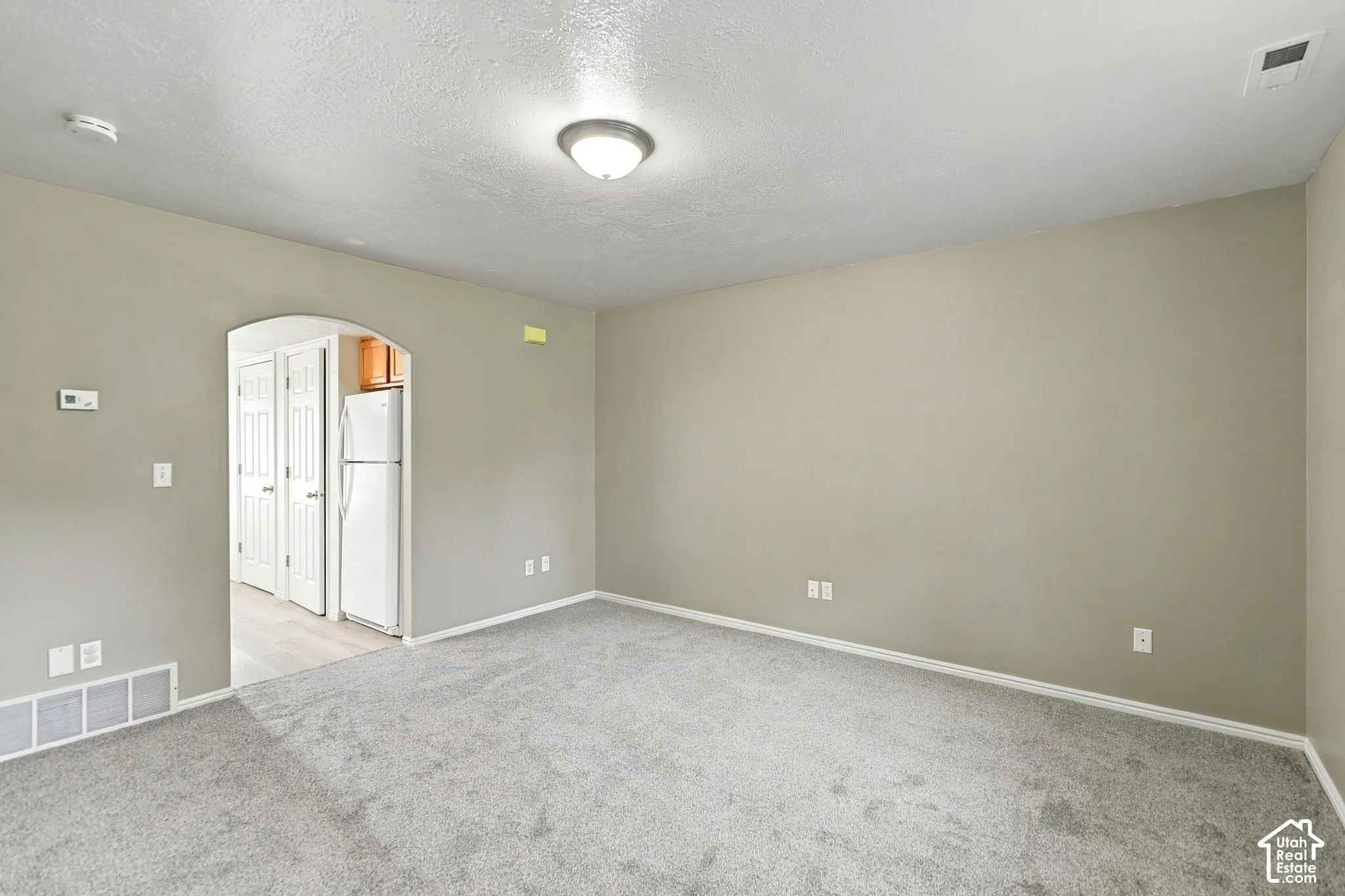 Spacious bedroom with neutral wall finishes, recessed ceiling lighting, and carpet flooring