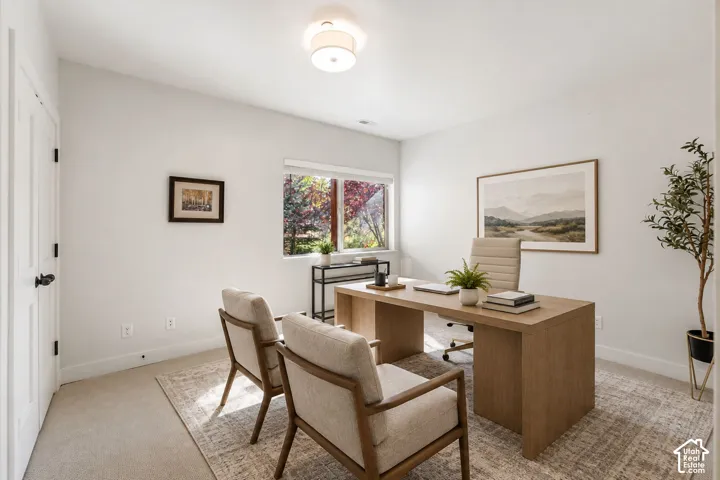 White painted walls, recessed lighting, and a window providing natural light