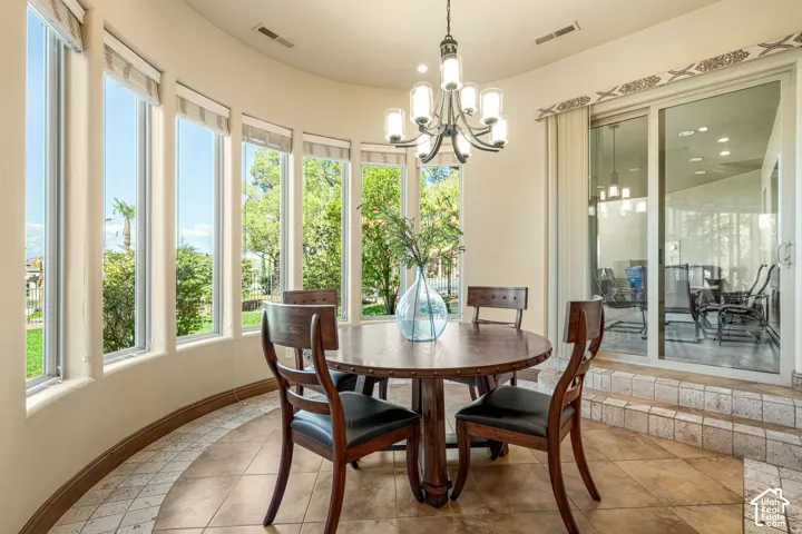 Curved wall with multiple windows, patterned tile flooring, and a sliding glass door