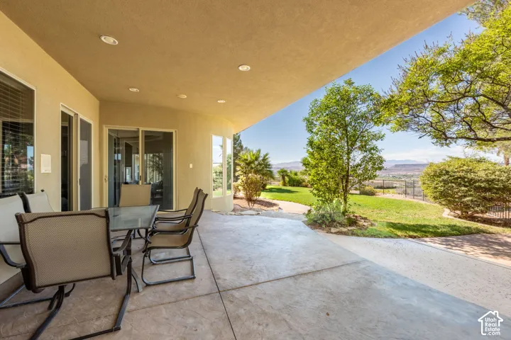 Covered patio with recessed lighting, multiple glass sliding doors, and a concrete surface