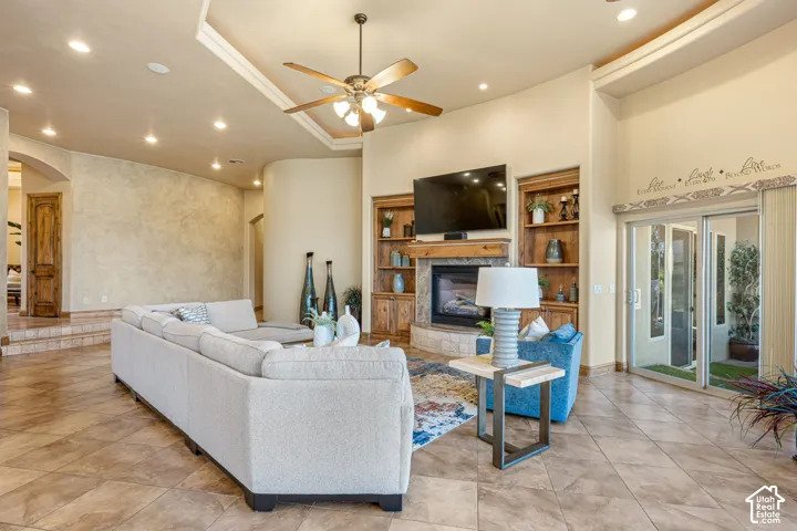 Tiled flooring, built-in shelving, fireplace, and sliding glass door