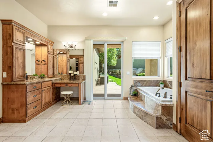 Built-in wood cabinetry with integrated mirrors, stone countertops, and a dedicated vanity area