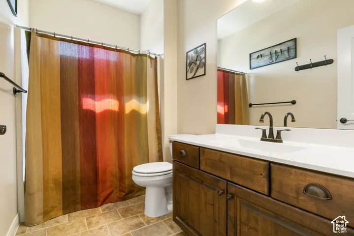 Spa-inspired bathroom featuring a wood-finish vanity with ample storage, white quartz countertop, and oil-rubbed bronze dual-handle faucet