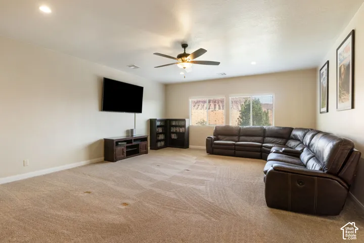 Recessed lighting, sloped ceiling, ceiling fan, carpeted flooring, and multiple windows with blinds