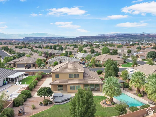 Terracotta tile roof, spacious backyard, in-ground swimming pool, lush landscaping, and integrated spa