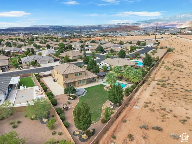 Two-story residence with a covered patio, expansive lawn, and a swimming pool