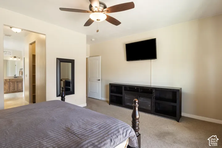 Ceiling fan with integrated lighting, built-in shelving, paneled interior door, recessed lighting, and carpeted flooring