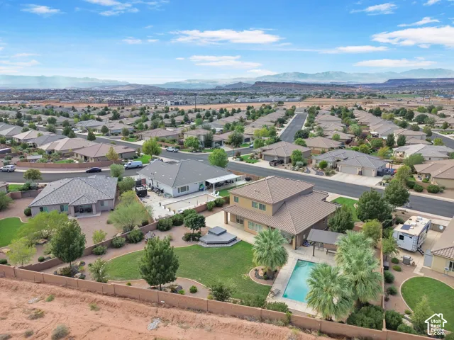 Aerial perspective showcasing a residential neighborhood with distant mountains