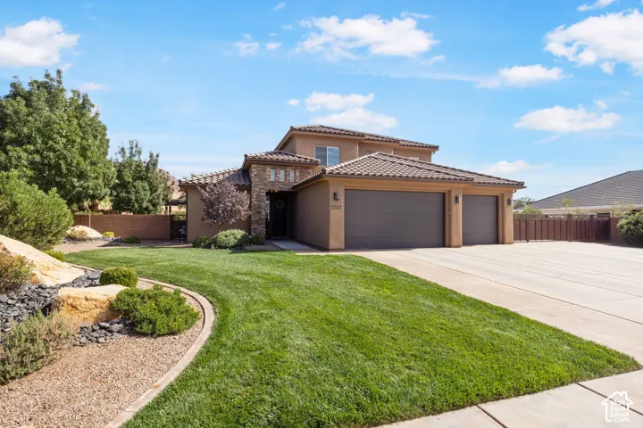 Stucco exterior with stone accents and a tile roof