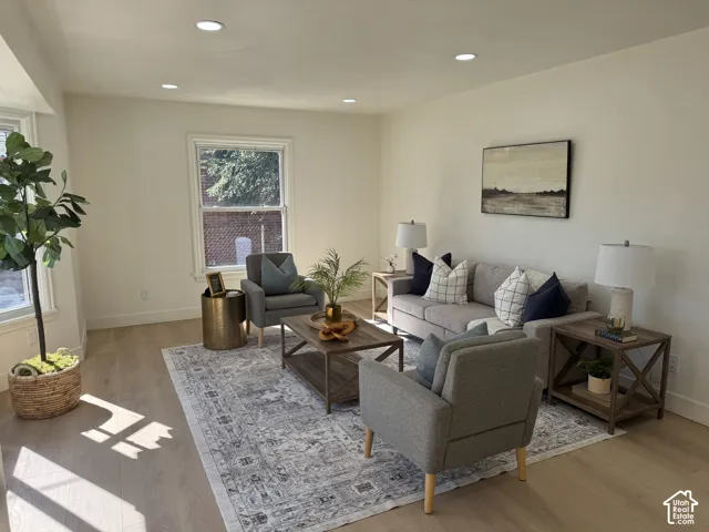 Recessed ceiling lighting, light wood-finish flooring, and white walls