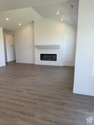 Great Room featuring vaulted ceiling and electric fireplace