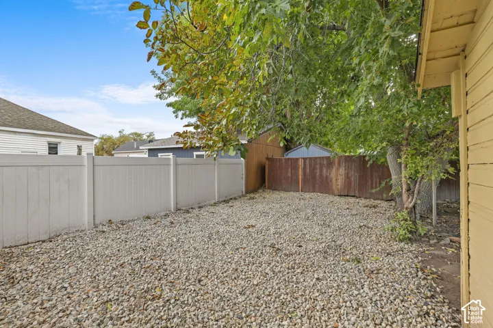 Pebble ground cover, perimeter fencing, and mature trees