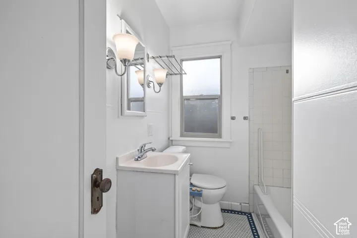 White vanity with an integrated sink, polished chrome faucet, and a wall-mounted mirror
