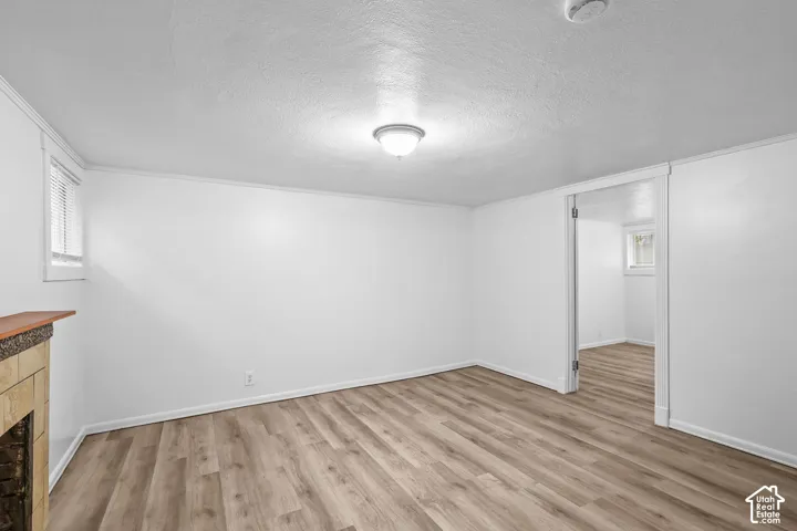 Wood-finish flooring, white walls, and a recessed ceiling light