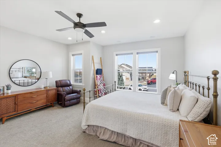 Recessed lighting, ceiling fan, carpeting, and multiple windows