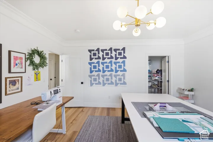 Crown molding, wood-finish flooring, recessed lighting, and a modern ceiling fixture