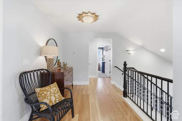 Light wood-finish flooring with white baseboards and light gray walls