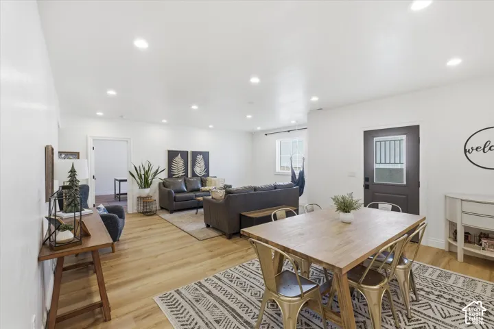 Open-concept living space featuring wood-finish flooring and recessed lighting