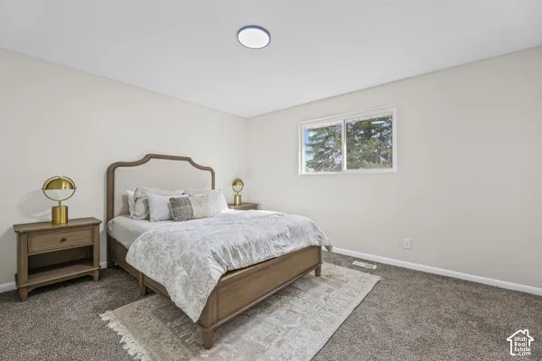 Neutral wall paint, ceiling-mounted light fixture, and a window providing natural illumination