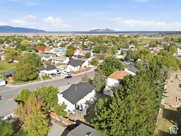 Aerial perspective showcasing a residential neighborhood with surrounding natural landscapes