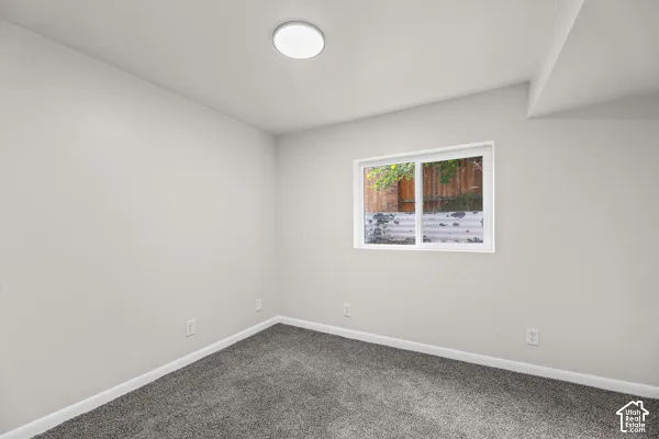 Neutral-toned walls complement the gray carpeting