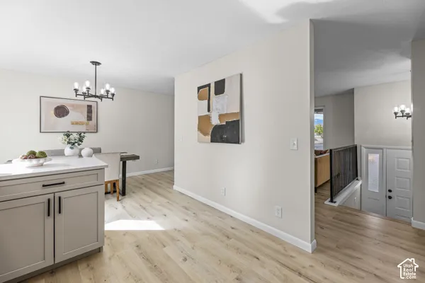 Wood-finish flooring throughout, with a built-in kitchen island featuring shaker-style cabinetry and a light-toned countertop