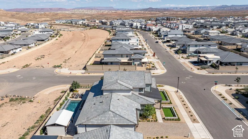 Aerial perspective of a developed residential area with multiple properties featuring gray shingled roofs