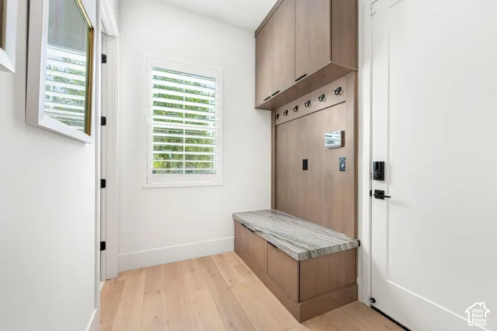 Built-in storage bench with a stone surface and upper cabinetry