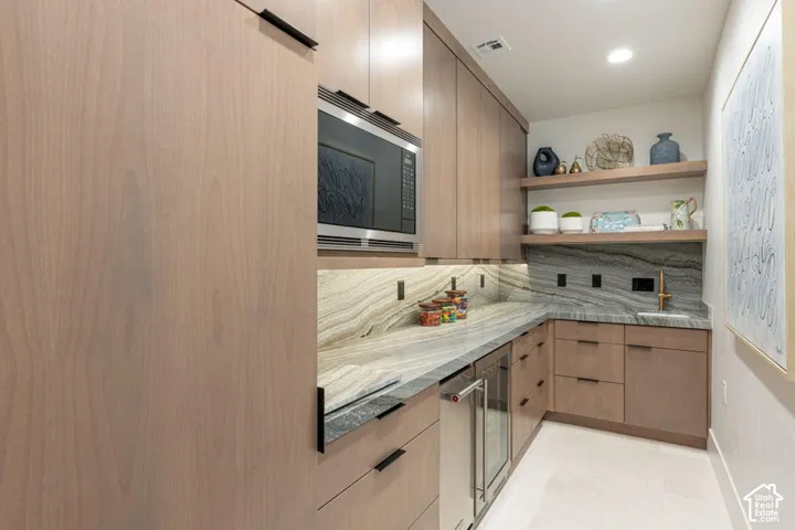 Integrated stainless steel microwave and beverage refrigerator