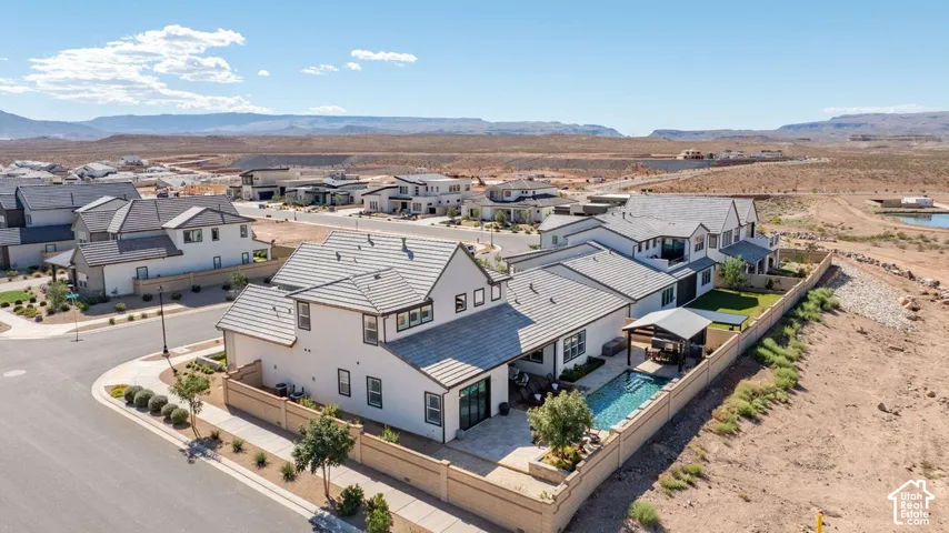 Modern stucco exterior with dark trim accents, a private swimming pool, and an attached covered patio