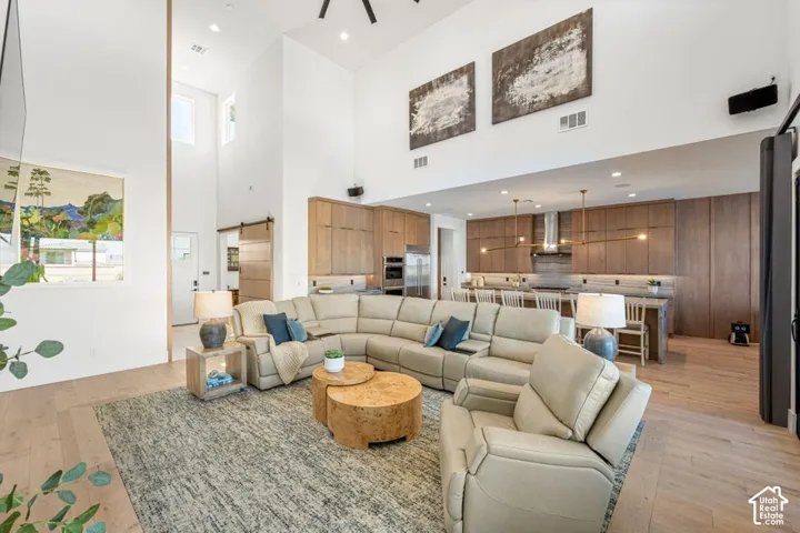 Vaulted ceilings, wood-finish flooring, custom wood cabinetry, stainless steel appliances, and recessed lighting