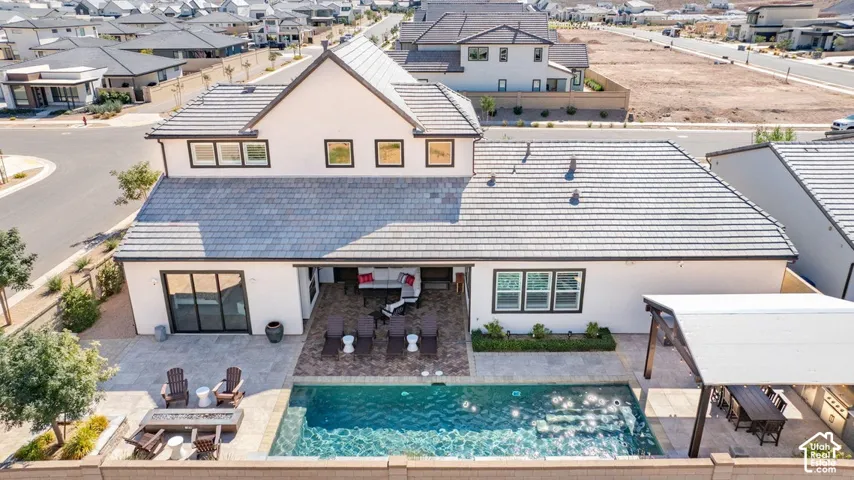 Contemporary residence featuring a multi-gabled roofline and a private backyard with an in-ground swimming pool