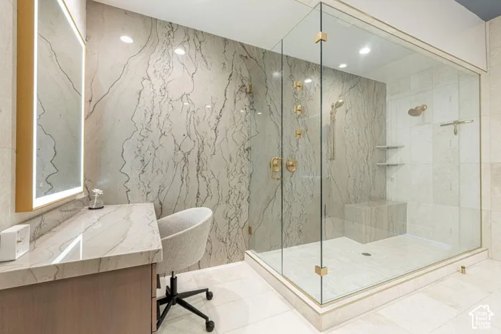 Walk-in shower with clear glass enclosure and built-in bench