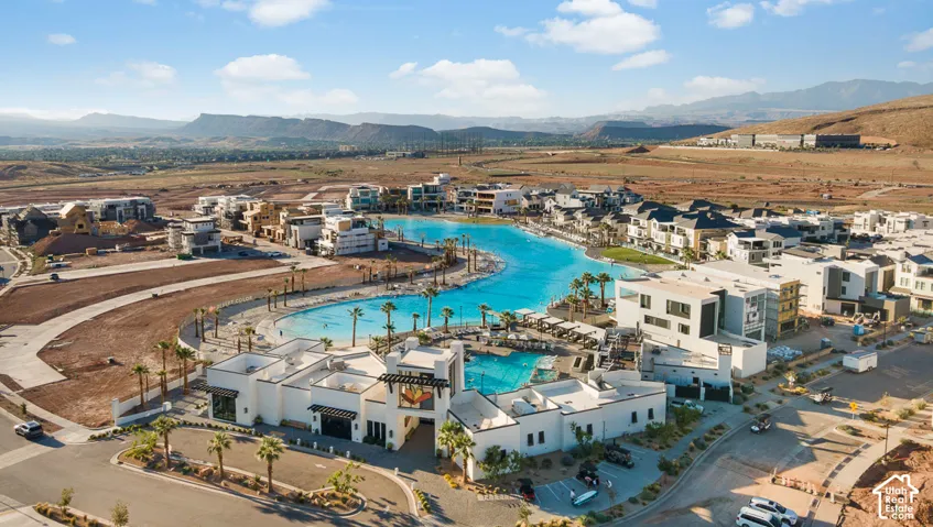 Waterfront property with resort-style amenities, including a large lagoon, multiple swimming pools, and extensive lounge areas