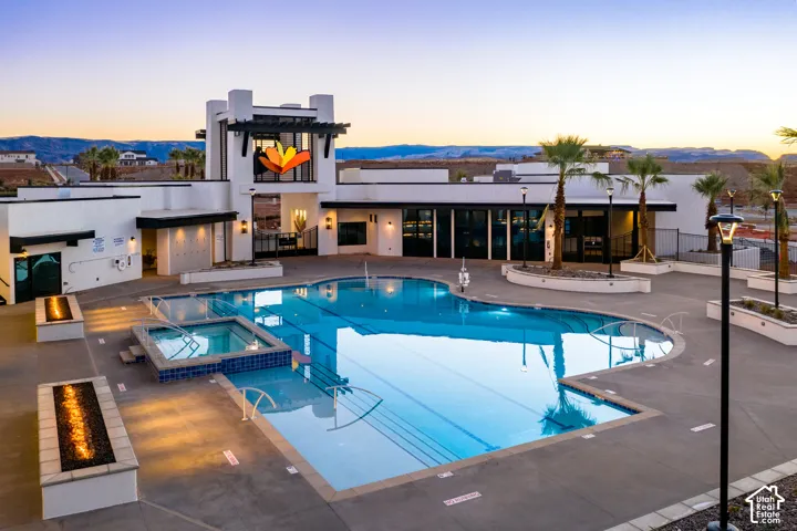 Community amenity building featuring an outdoor pool, integrated spa, and fire pit