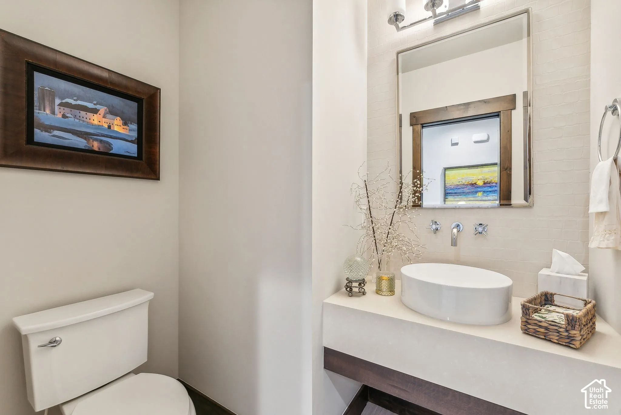 Modern powder room featuring a circular vessel sink with a polished countertop, framed mirror with integrated lighting, and subway tile wall finish
