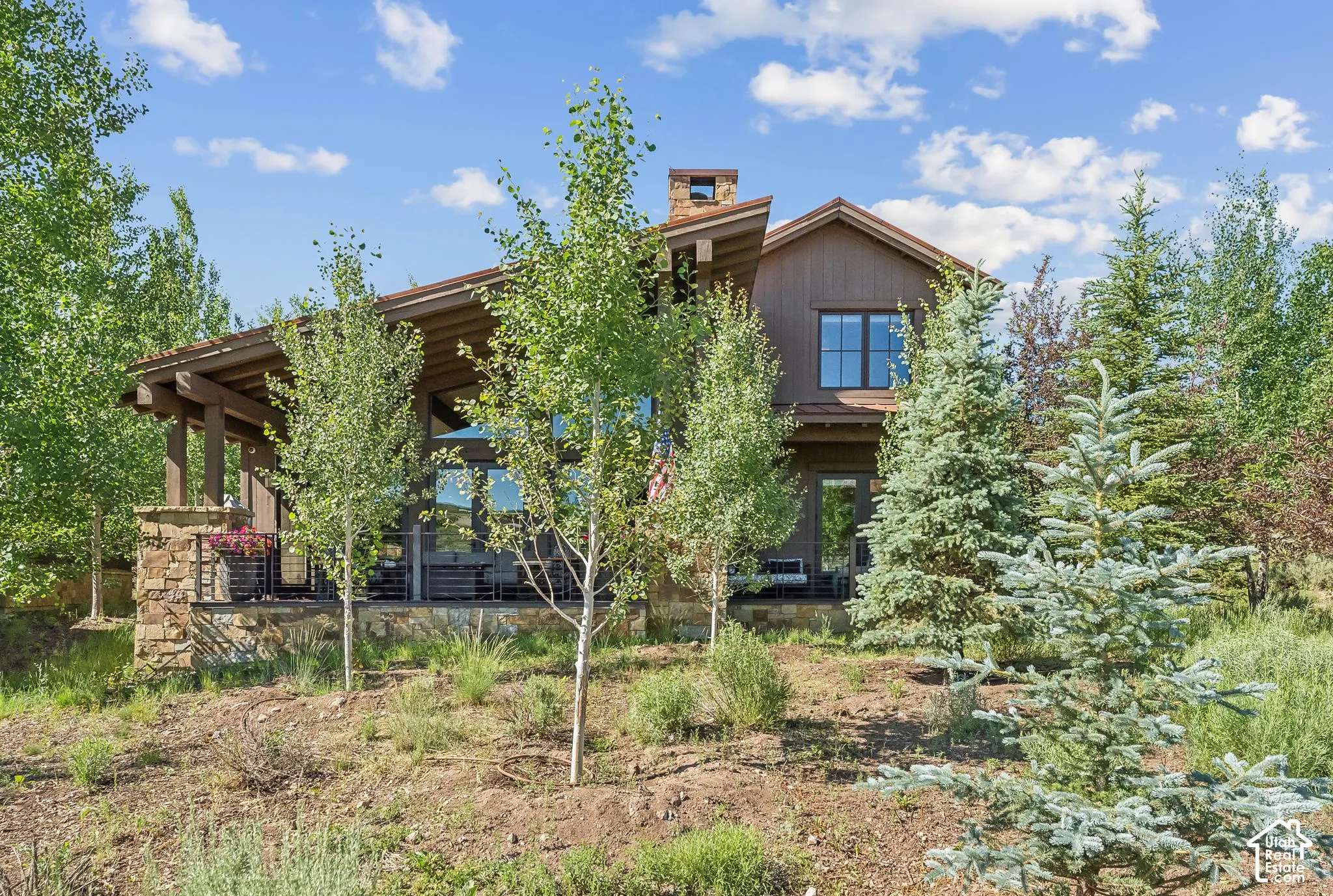 Wood-clad exterior with stone accents and a covered patio