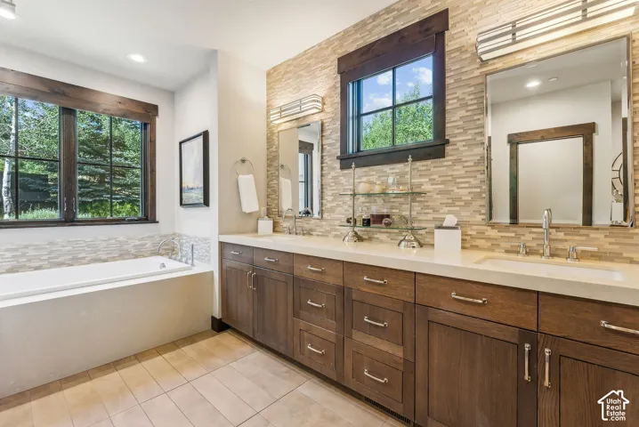 Dual vanity with integrated sinks and extensive wood-finish cabinetry