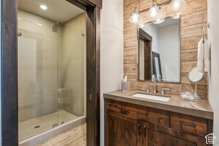 Glass-enclosed shower with tiled walls and floor