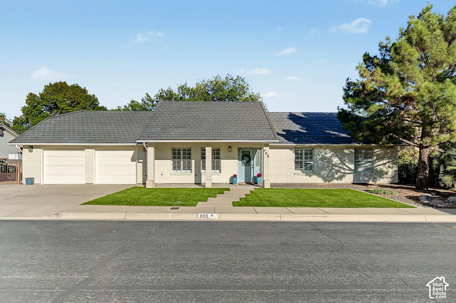 White brick and stucco exterior with a gray shingle roof