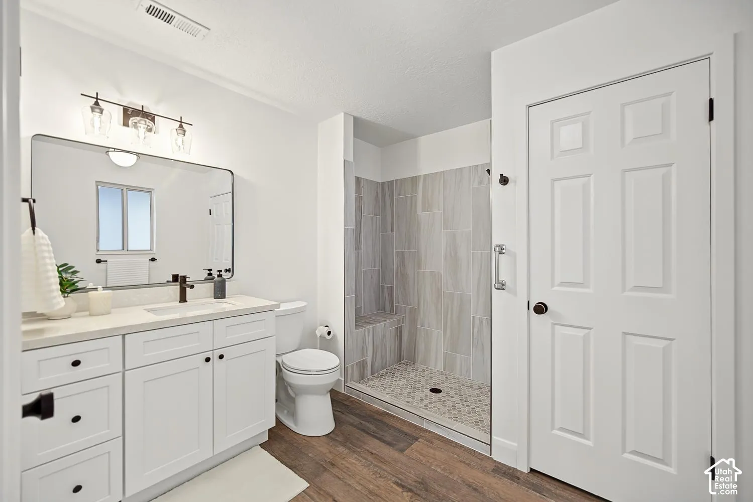 White shaker-style vanity with a light-colored countertop