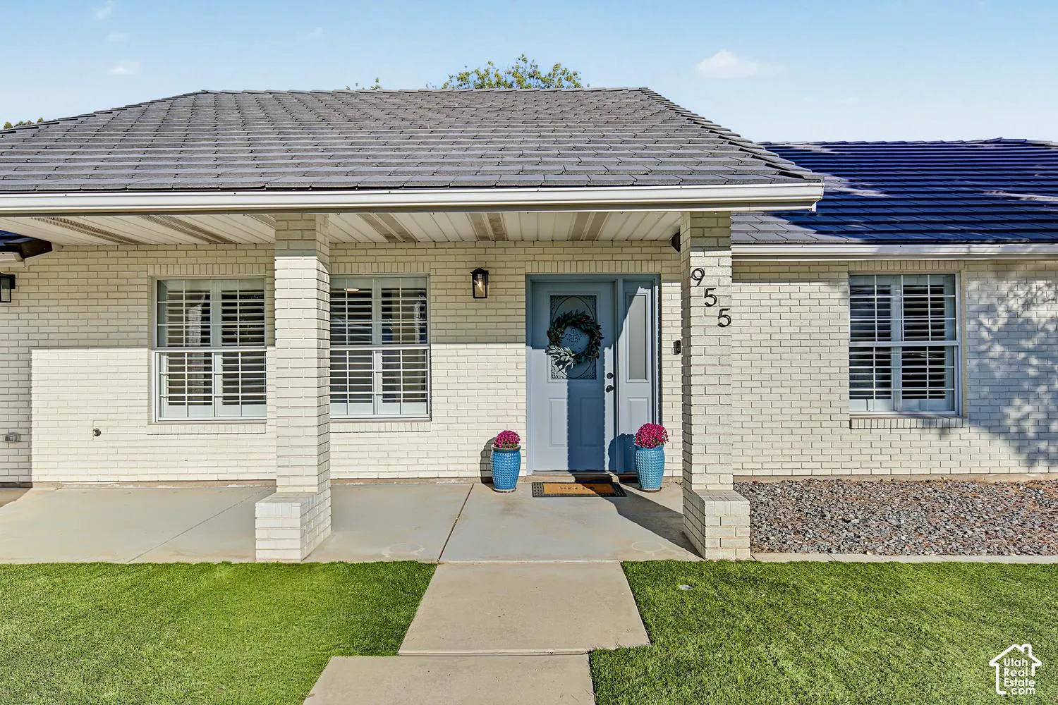Welcoming brick facade with shuttered windows and a covered entry portico