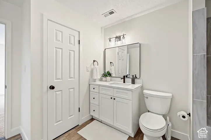 White vanity with a white countertop and rectangular undermount sink