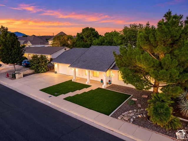 Single-story residence featuring a gray tile roof and white exterior