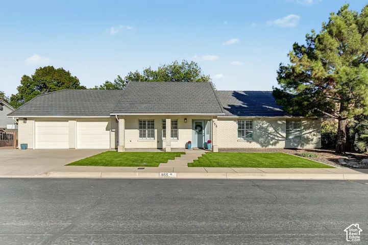 White brick and stucco exterior with a gray shingle roof