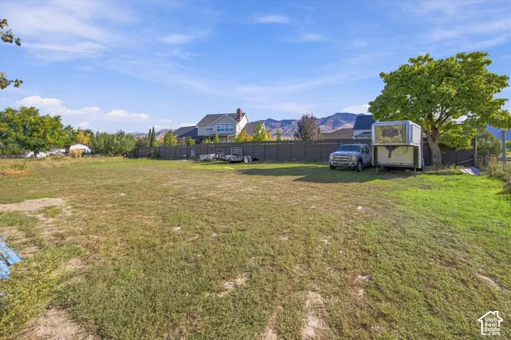 Expansive lot with mature trees and mountain backdrop